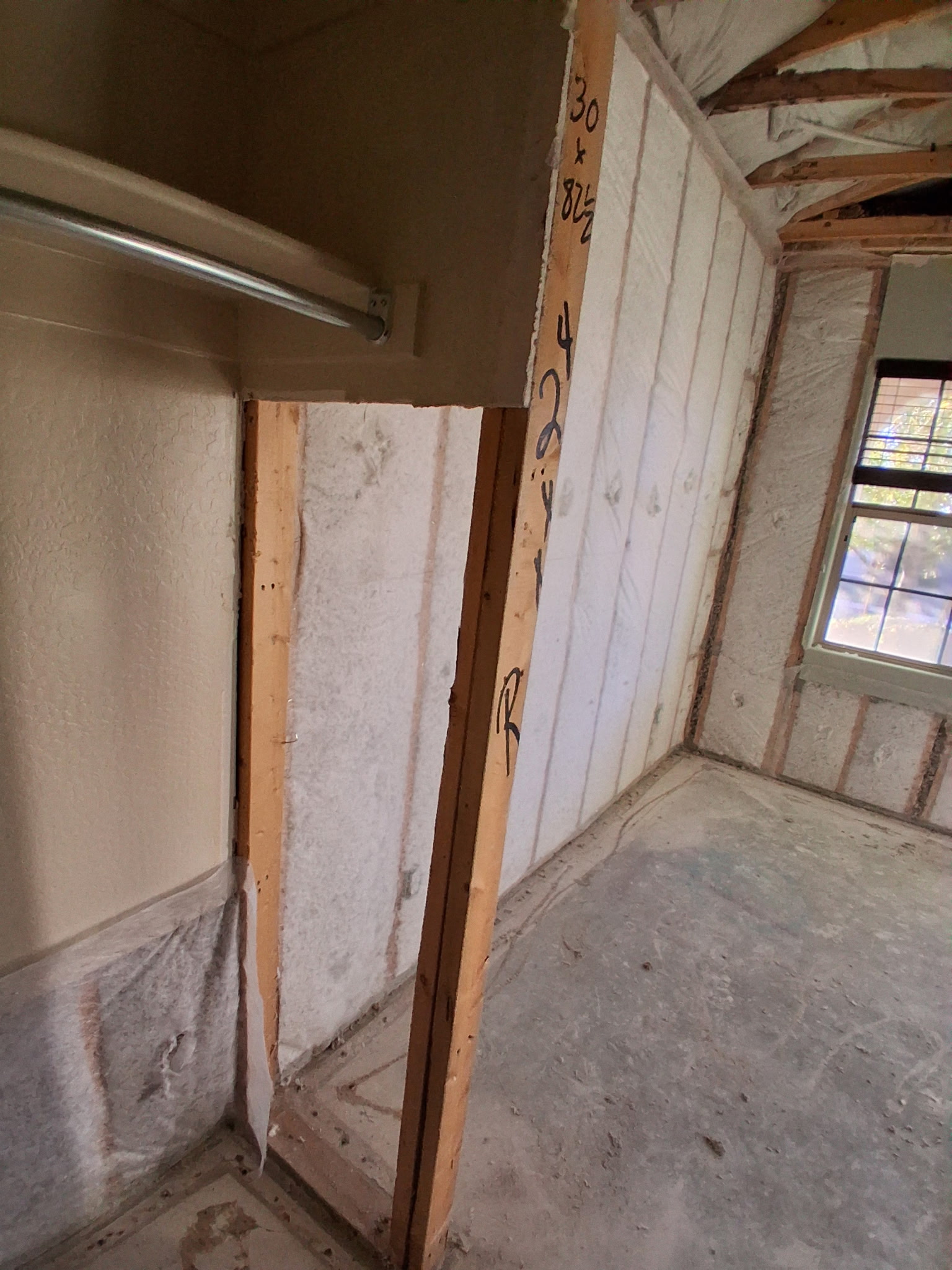 Open wall framing before drywall restoration