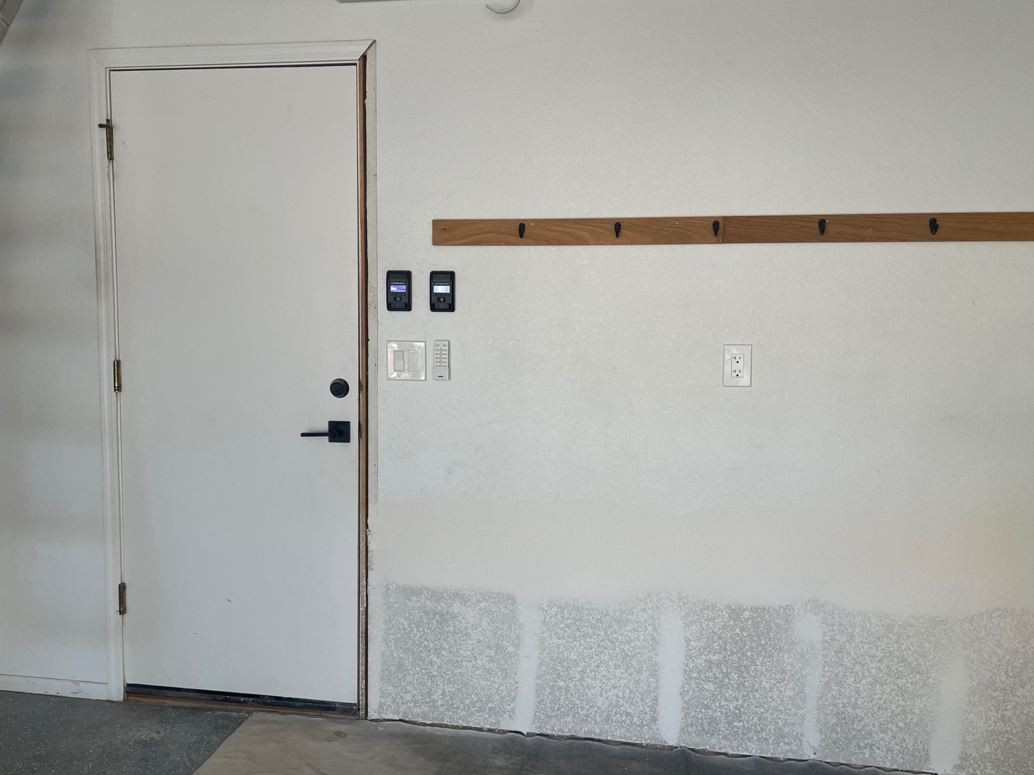 Drywall repair work beside a garage entry door